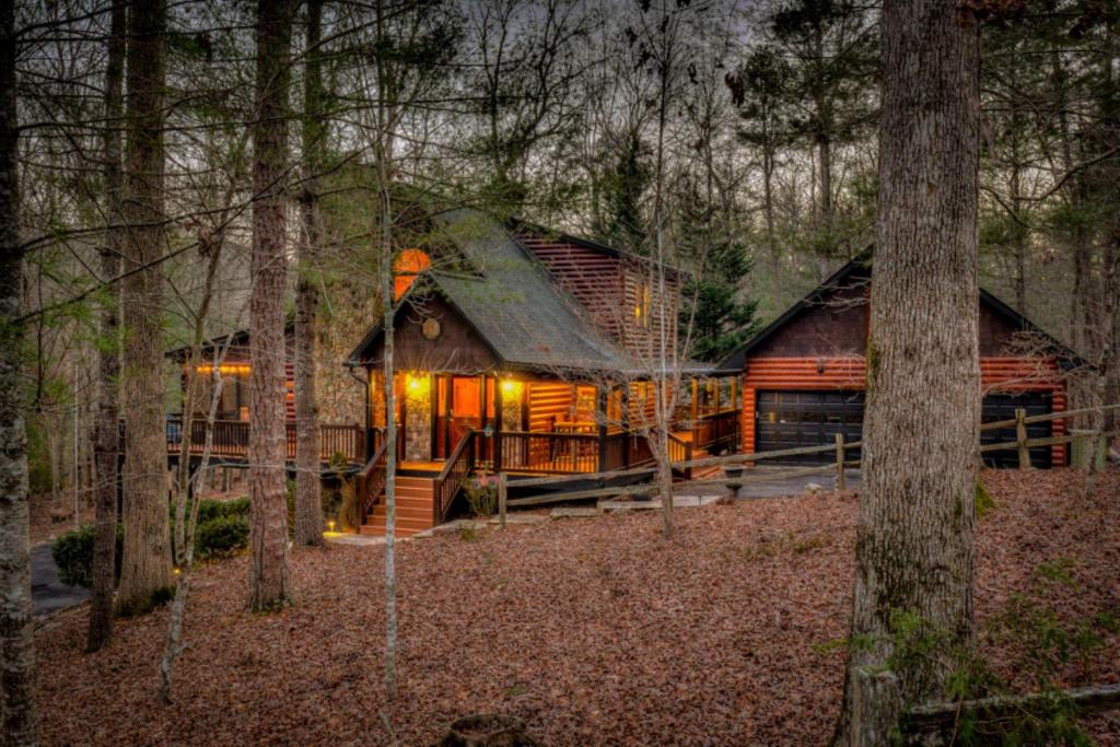 a log cabin in the woods with trees at Love You Deerly in Morganton