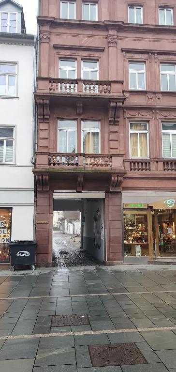 a brick building with a balcony on top of it at Von privat, Großes Zimmer sehr zentral in Bad Homburg Stadtmitte in Bad Homburg vor der Höhe