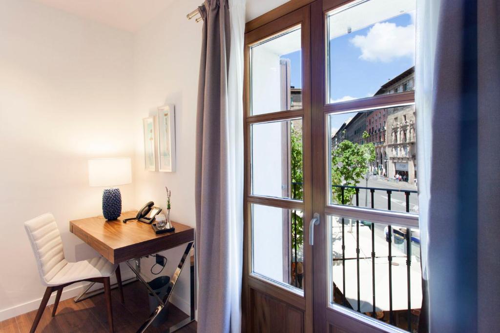 a room with a wooden table and a window at Hotel Bosch Boutique in Palma de Mallorca