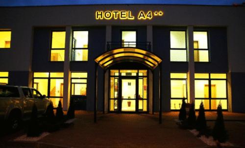 un edificio con entrada a un hotel por la noche en Hotel A4 MOP Zastawie, en Jaworzno