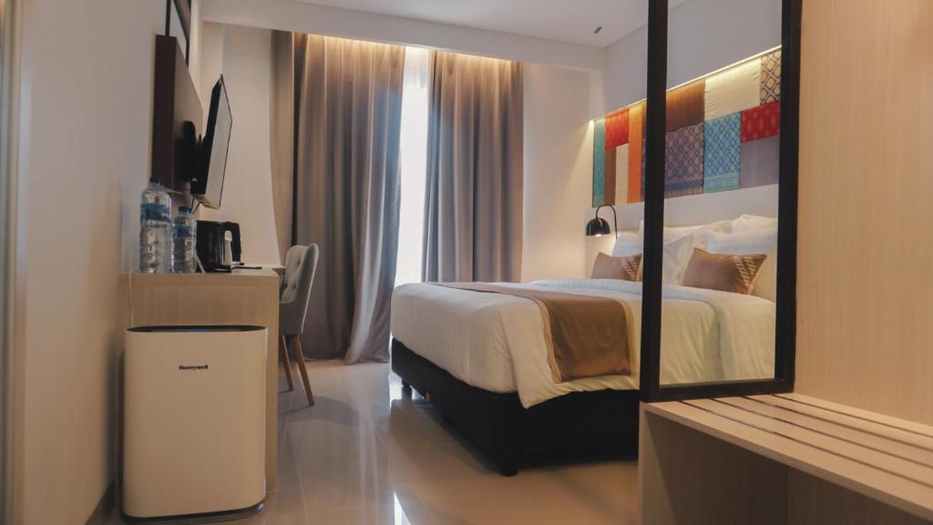 Postel nebo postele na pokoji v ubytování Patra Dumai Hotel