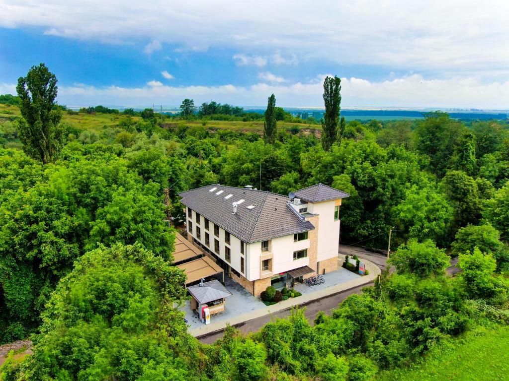 an overhead view of a house in the woods at Hotel & Relax Zone Cattleya in Krushuna