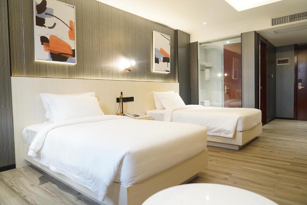 Postel nebo postele na pokoji v ubytování Joy Hotel