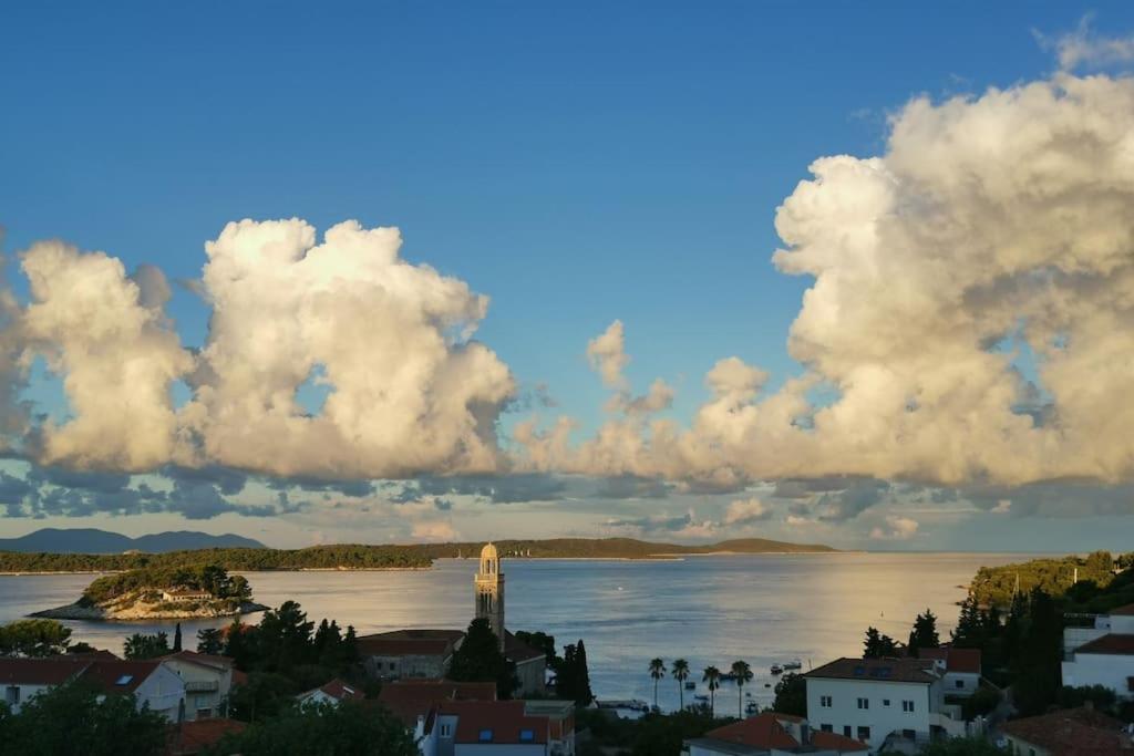 a large body of water with a town and a lighthouse at All About the Sea - Riviera House near the center of Hvar in Hvar