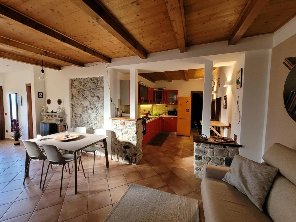 a kitchen and a living room with a table and chairs at Il Pozzo in Tremezzo