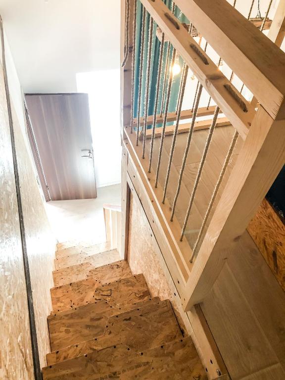 a staircase in a house with a metal railing at Kisas Loft By Pinch in Pakoštane