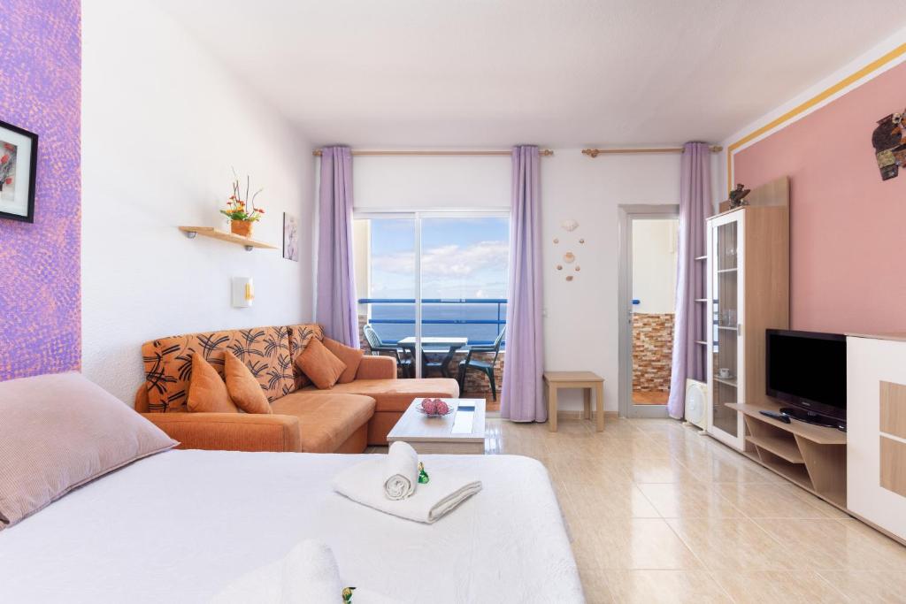 a living room with a bed and a couch at Adeje Paraíso in Adeje