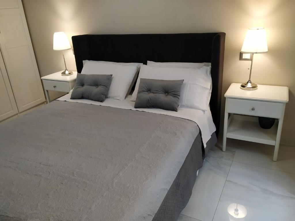 a bedroom with a large bed with two night stands at Sotto le Mura in Messina