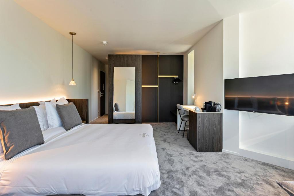 Postel nebo postele na pokoji v ubytování Hotel Astoria