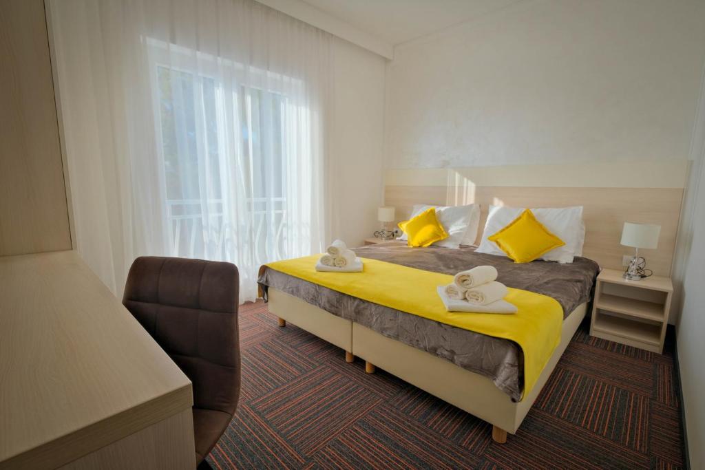 a hotel room with a bed with towels on it at Hotel Bor in Krk