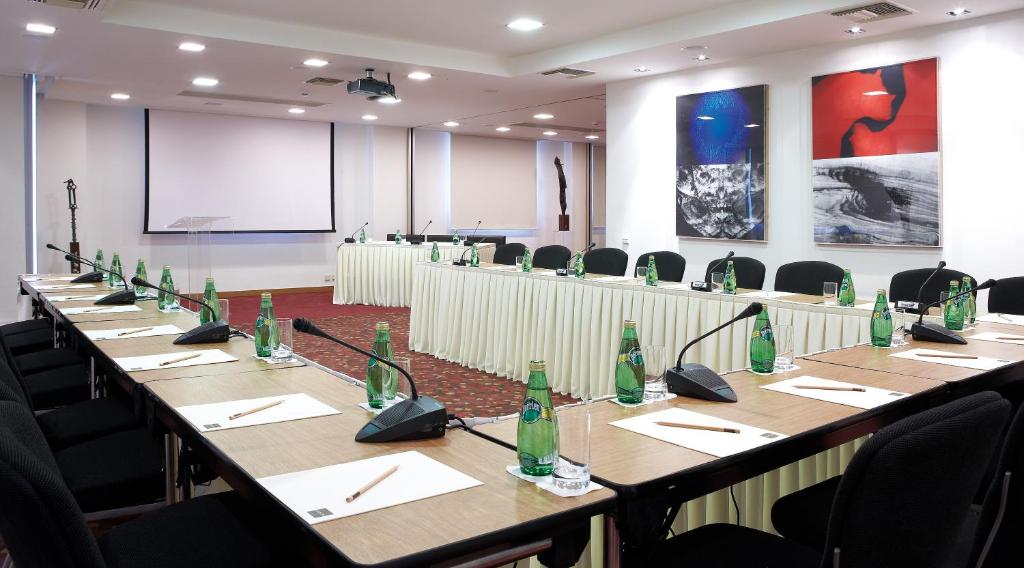 a conference room with a long table with bottles on it at Daios Luxury Living in Thessaloniki