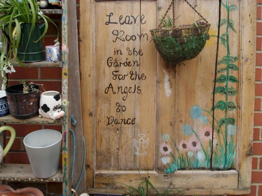 a wooden door with a sign written on it at Florita - Dawlish in Dawlish