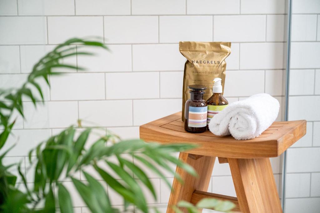 a wooden shelf with a towel and a bottle of soap at Doghouse Margate in Kent