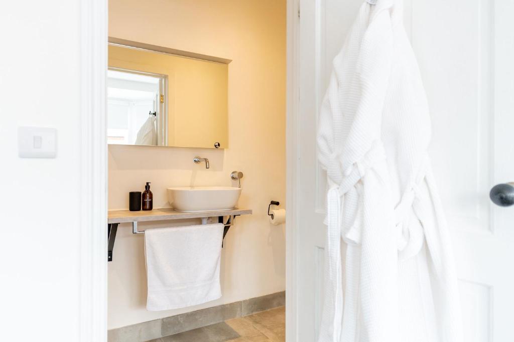 a bathroom with a sink and a mirror at Doghouse Margate in Kent