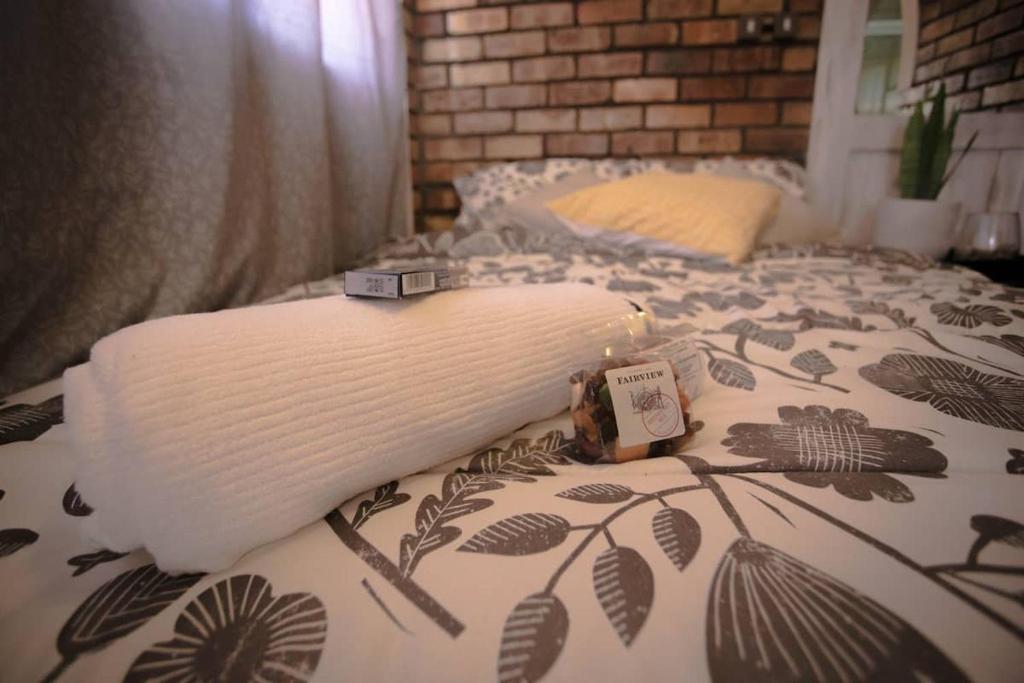 a bed with a blanket on top of it at Lovely 1-bedroom Garden Cottage in Klerksdorp
