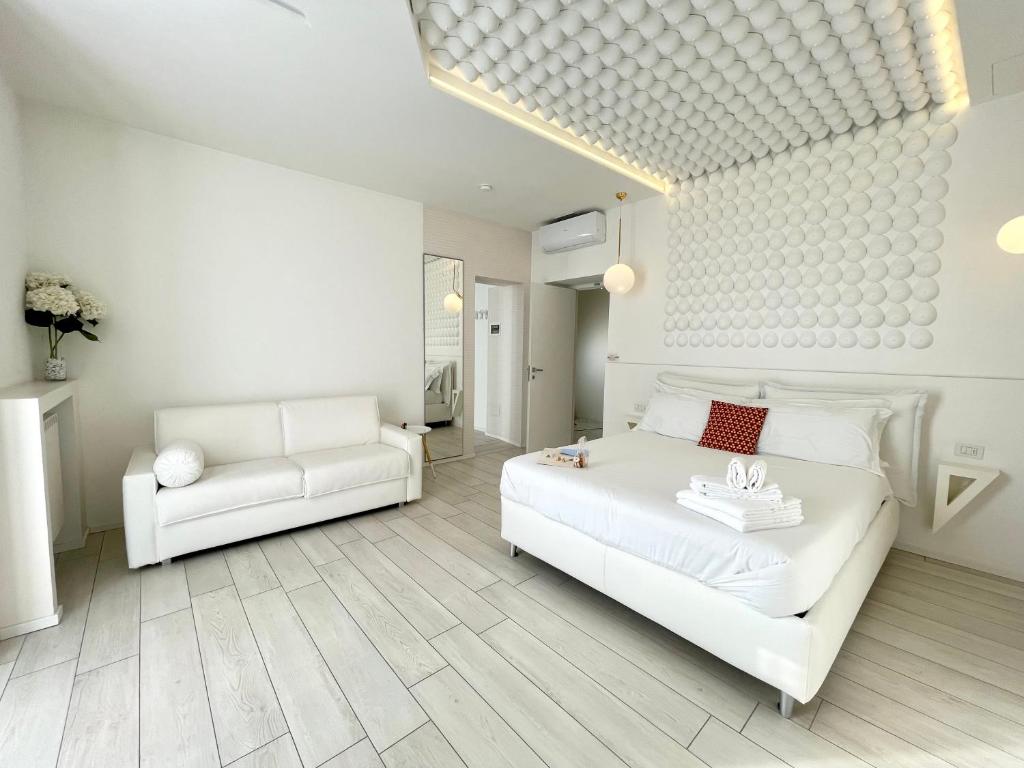 Posteľ alebo postele v izbe v ubytovaní Mariarosa Suites