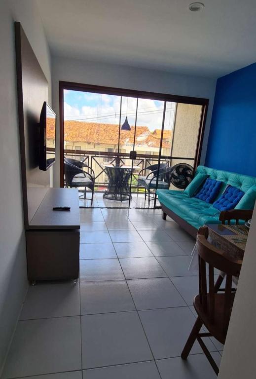 a living room with a couch and a table at Flats family in Gravatá