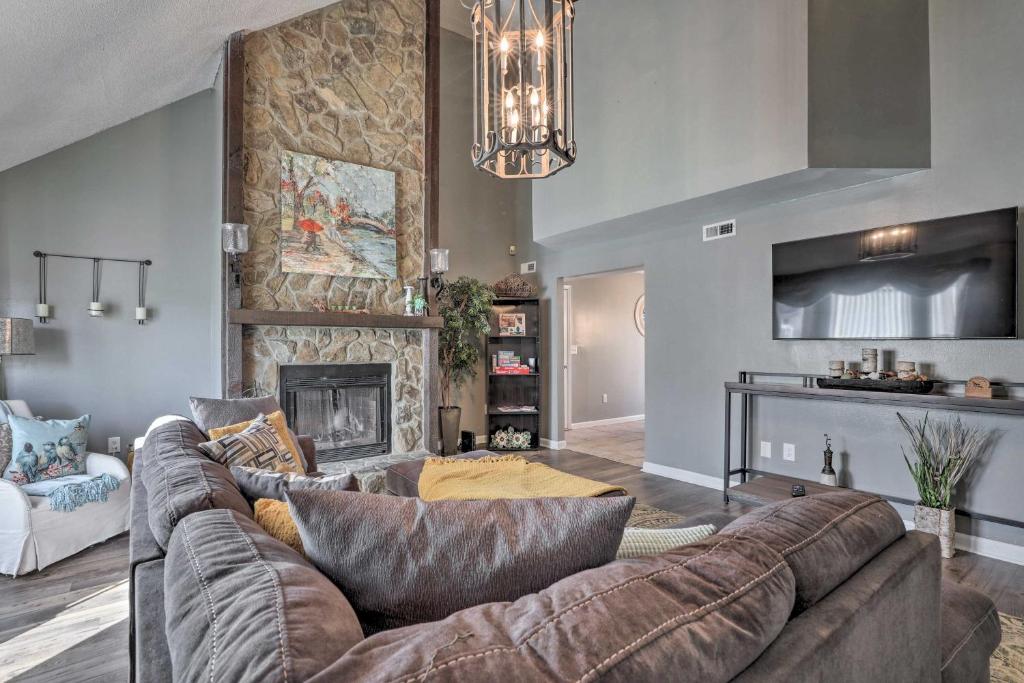 a living room with a couch and a fireplace at Fire Pit, Gazebo and Hot Tub North Charleston Home! in Charleston