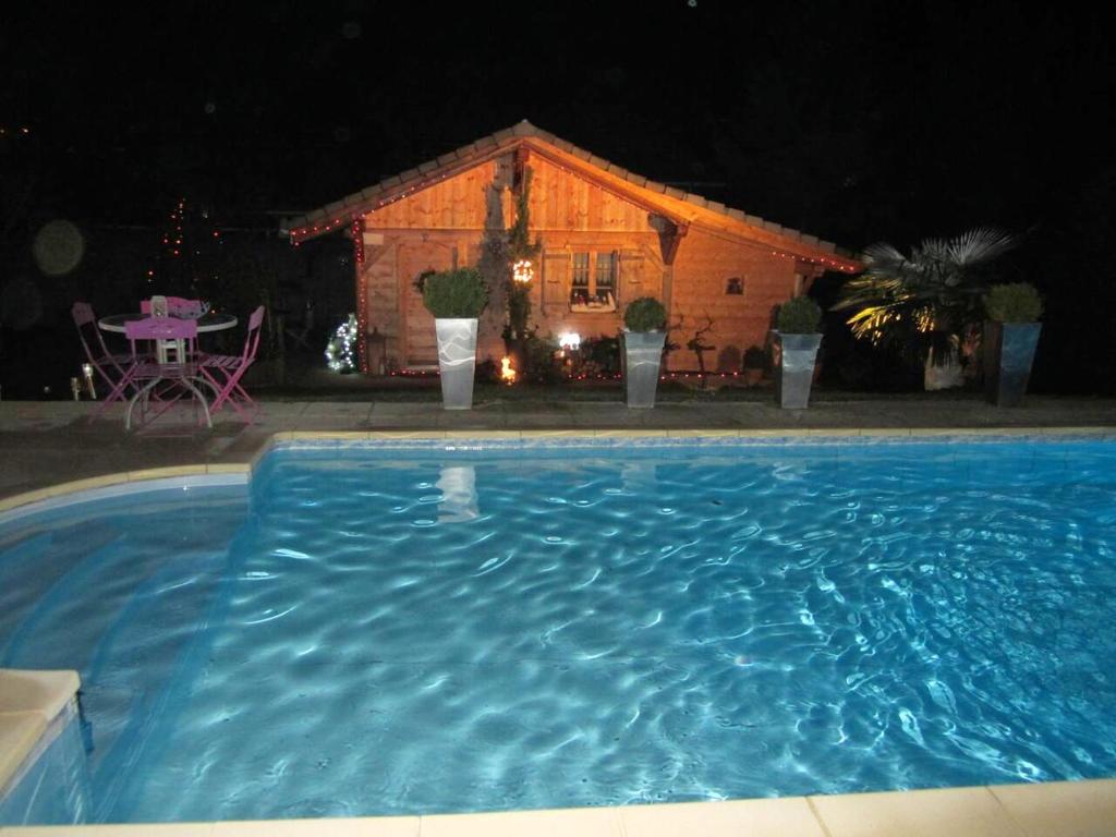 een zwembad voor een huis 's nachts bij Villa d'une chambre avec piscine privee sauna et jardin clos a Allinges in Allinges