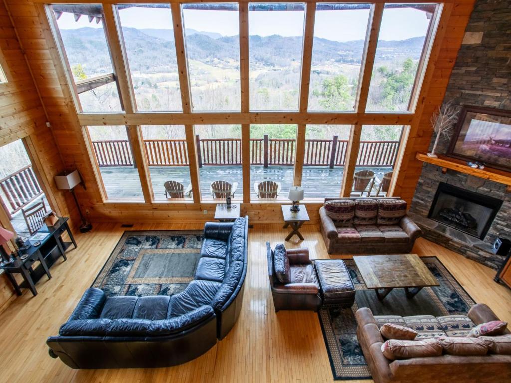 a living room with couches and a large window at Copper Top - Stunning Views, and Hot Tub in Sevierville