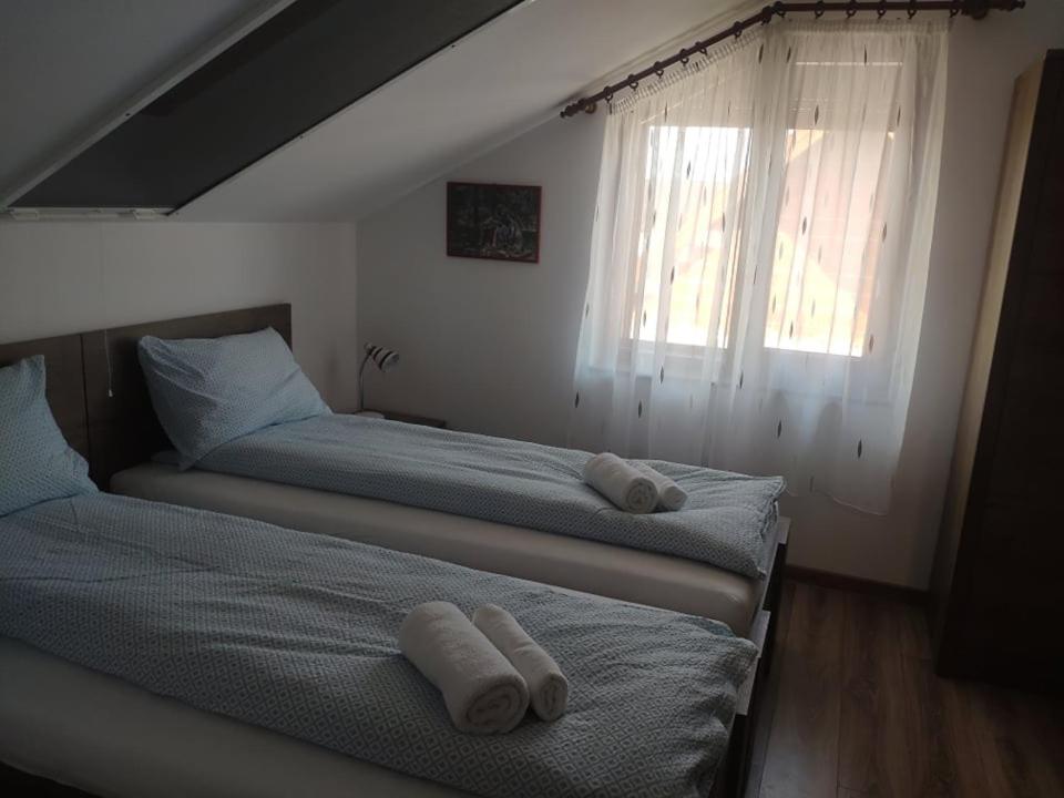 A bed or beds in a room at Gondos Vendégház