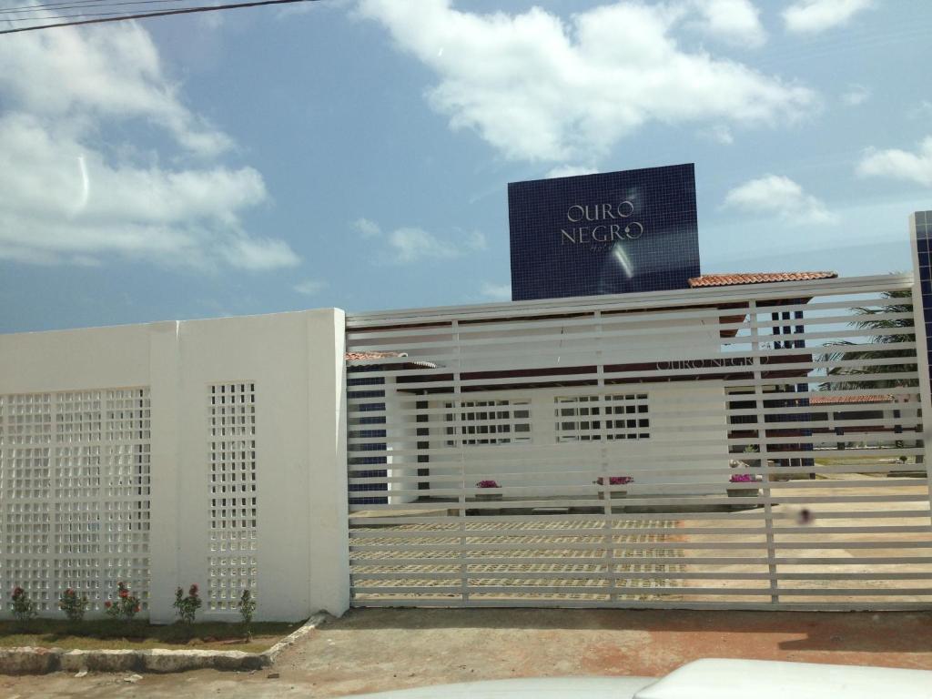 a building with a sign on top of it at Hotel Ouro Negro in Guamaré