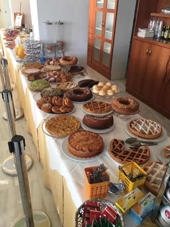 a long table filled with lots of pies and pastries at Hotel Royal in Giulianova
