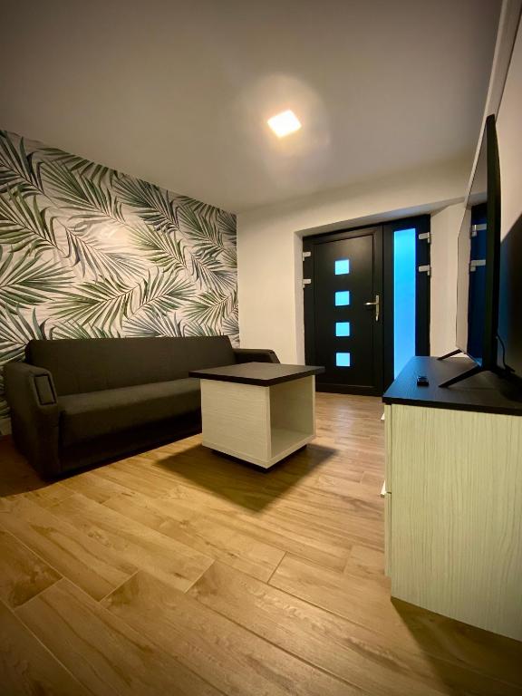 a living room with a couch and a table at Apartma Sinitus in Izola