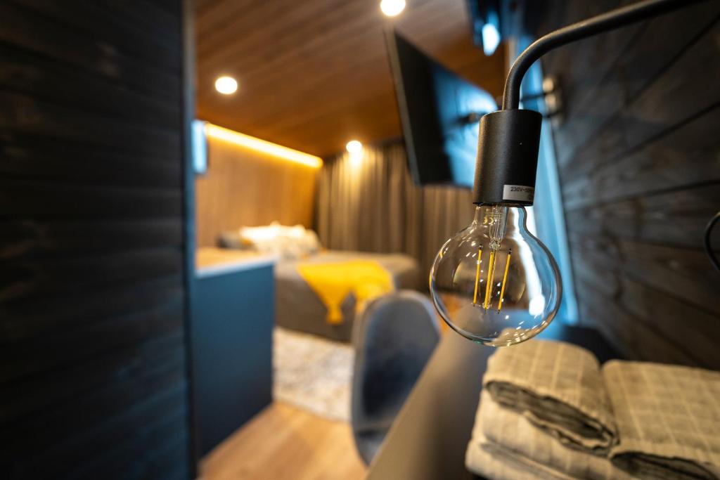 a light bulb hanging on a wall in a room at Black Hotel in Kempele
