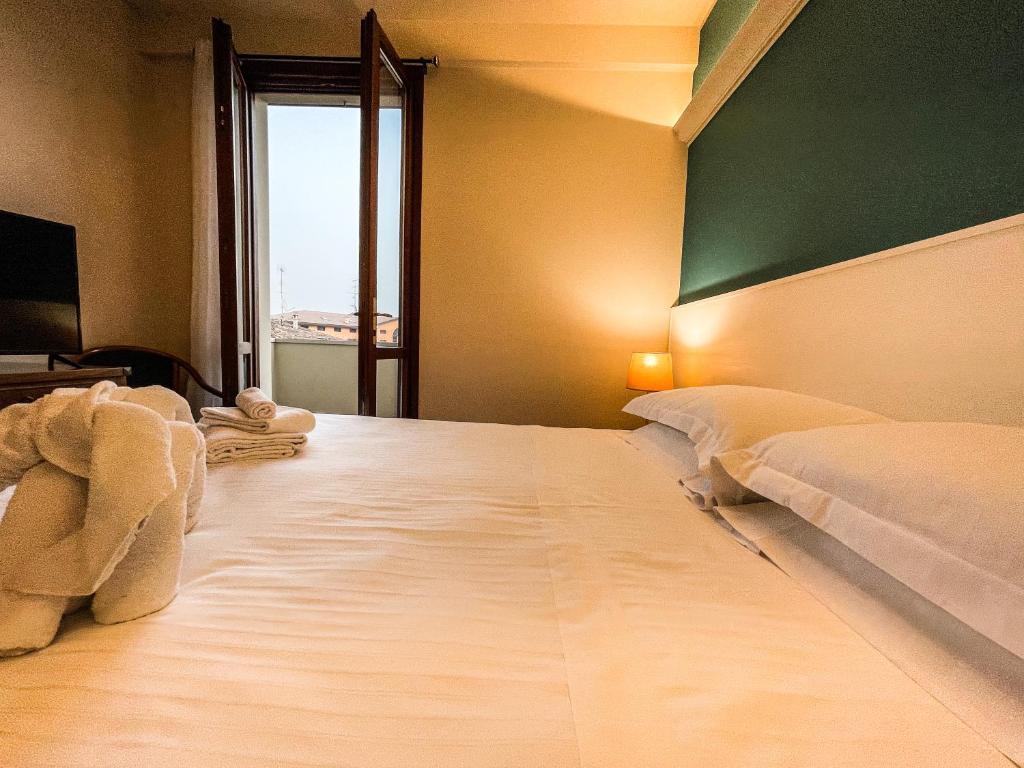 Posteľ alebo postele v izbe v ubytovaní Hotel Elefante