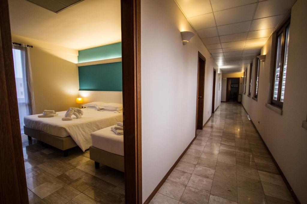 Posteľ alebo postele v izbe v ubytovaní Hotel Elefante