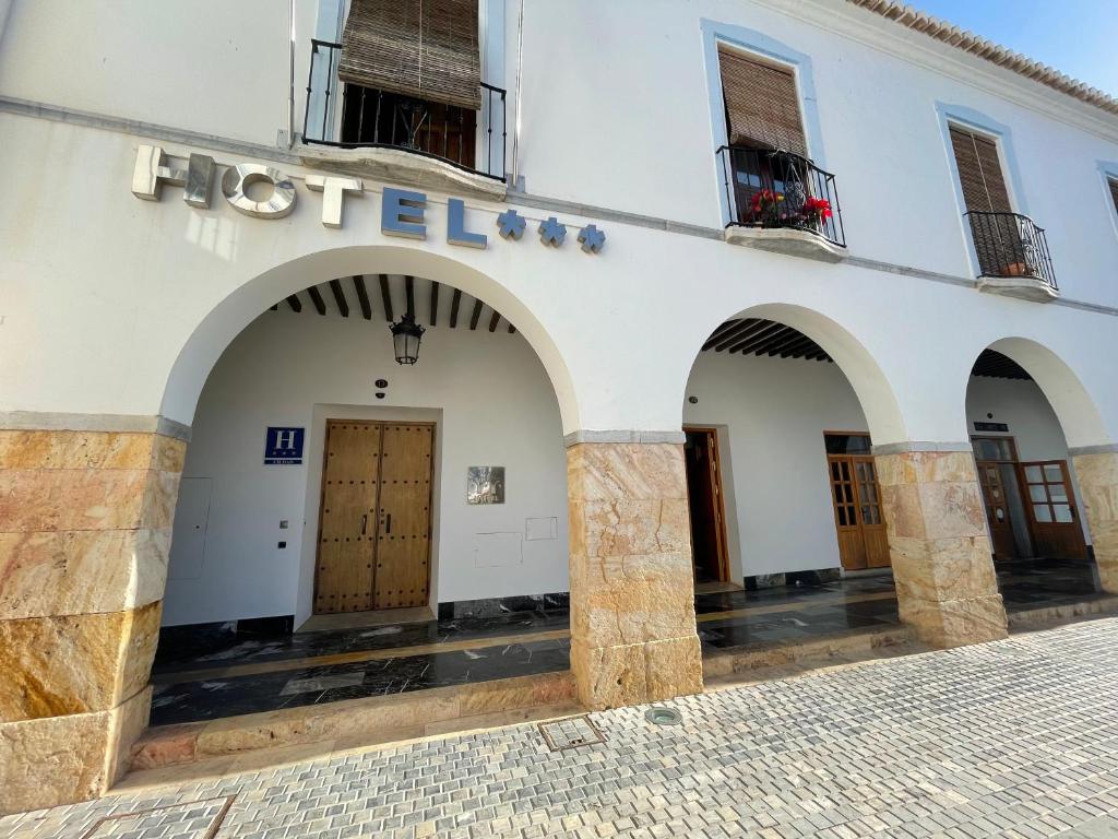 a hotel with arches on the side of a building at Hotel Don Miguel Plaza in Berja