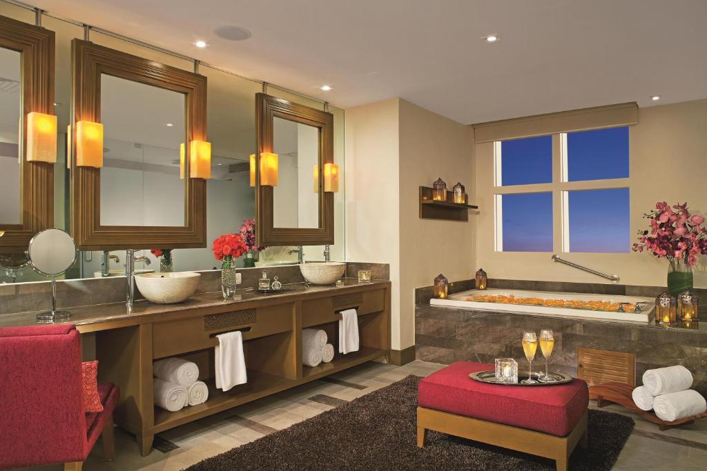 a bathroom with two sinks and a bath tub at Secrets Vallarta Bay Resort & SPA - Adults Only in Puerto Vallarta