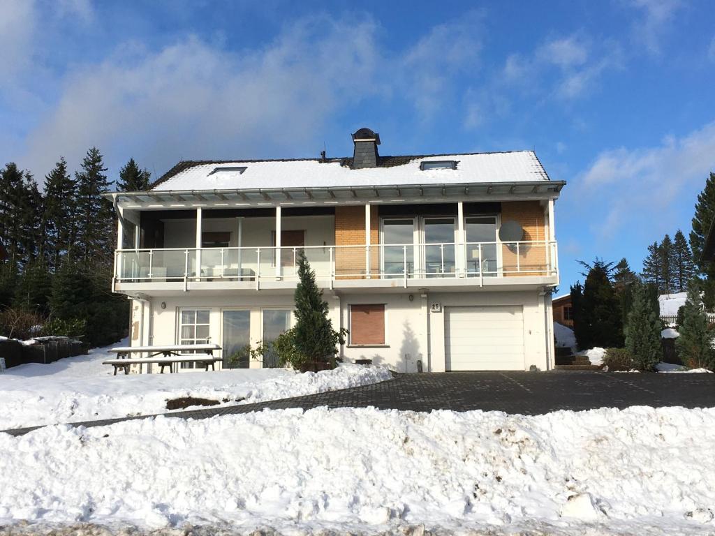 a large white house in the snow at Familiehuis Hannelore in Winterberg