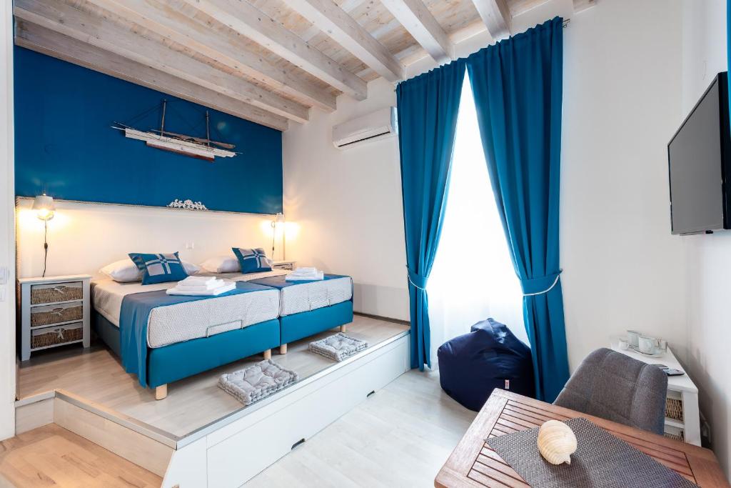 a bedroom with a bed with a blue wall at Nautica Room 1 - Old Town in Dubrovnik