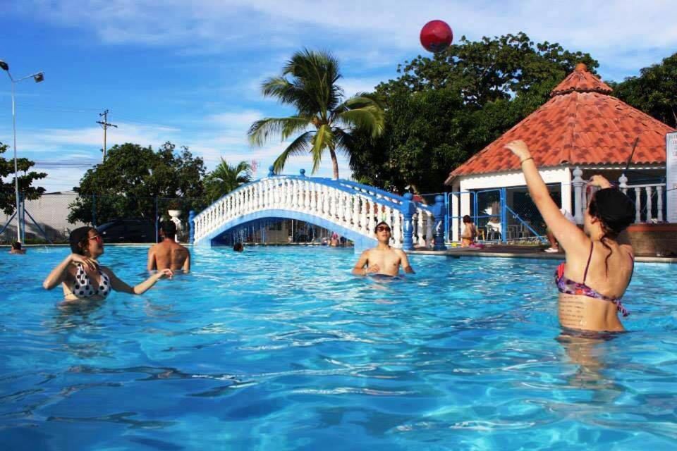 a group of people in the swimming pool at a resort at Royal Resort Flandes in Flandes
