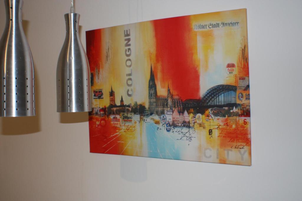 a painting hanging on a wall next to two vases at Apartment 60 m² in Elsdorf-Heppendorf in Elsdorf