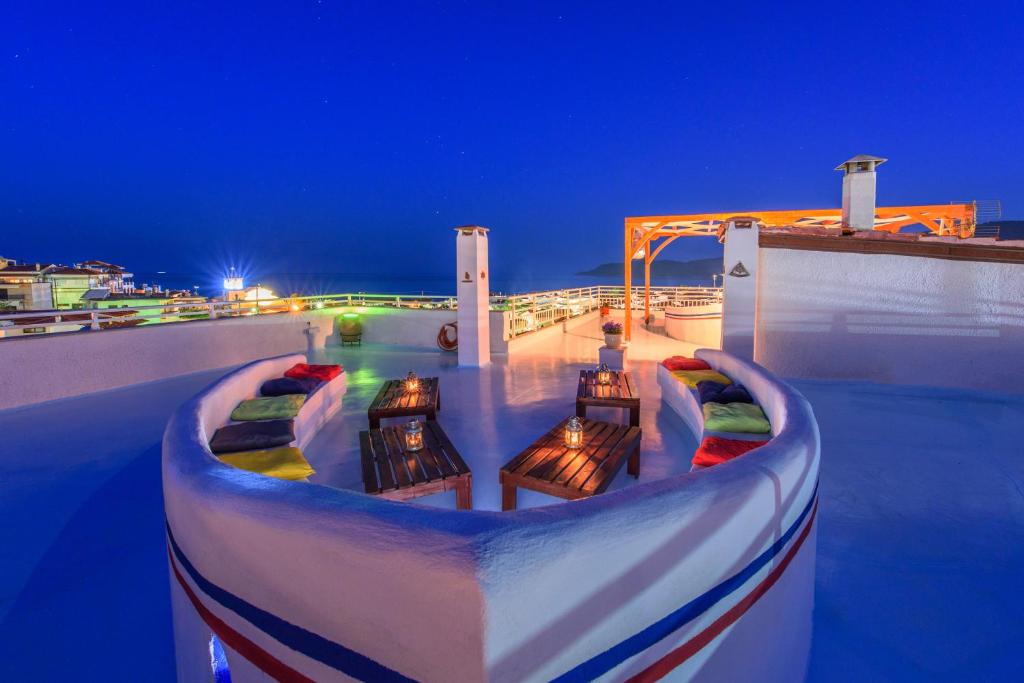 a deck with benches on top of a building at night at Aristea Studios in Sarti