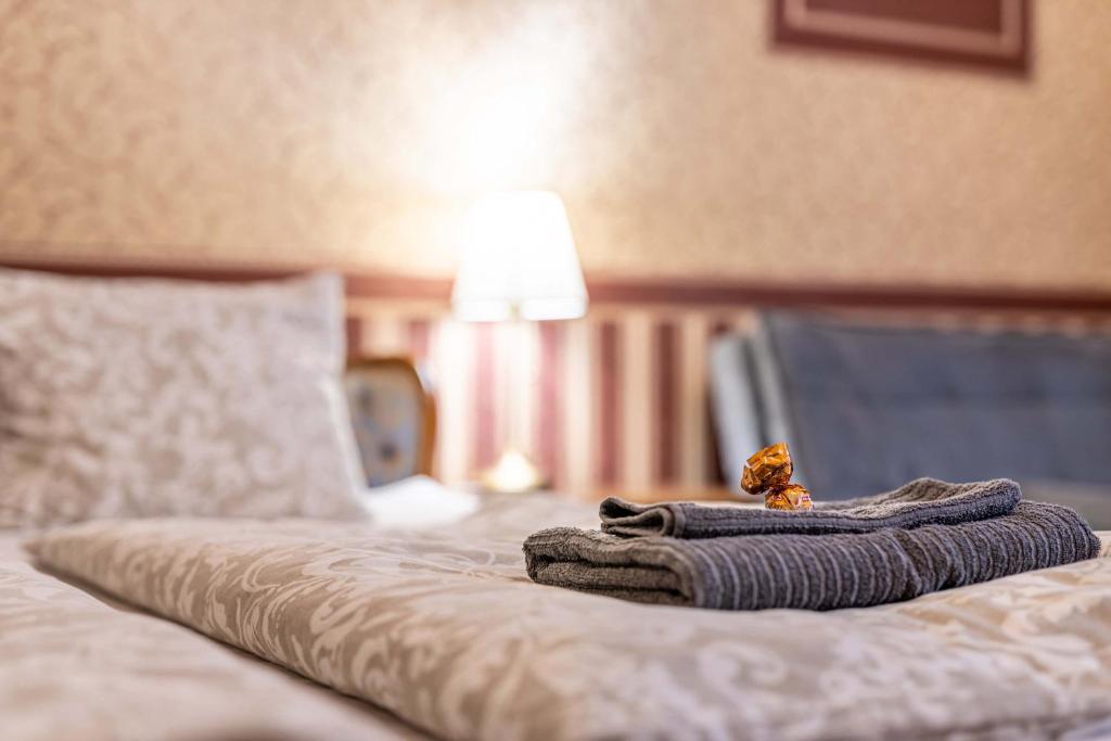 a pile of towels sitting on top of a bed at Josephine Studio in Budapest