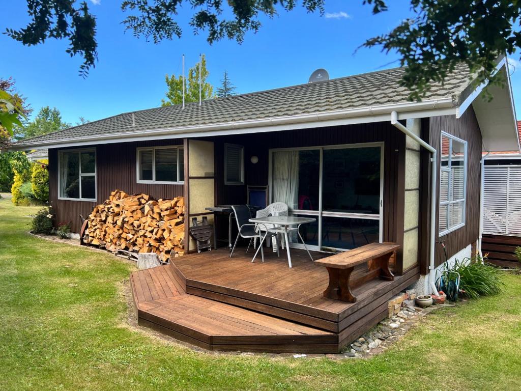 a wooden deck with a bench on a house at 2 Alpine Avenue in Hanmer Springs