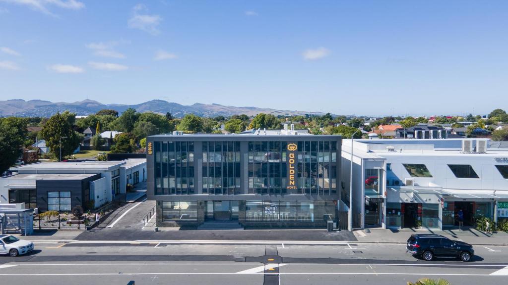 an aerial view of a building with a parking lot at Golden Hotel in Christchurch