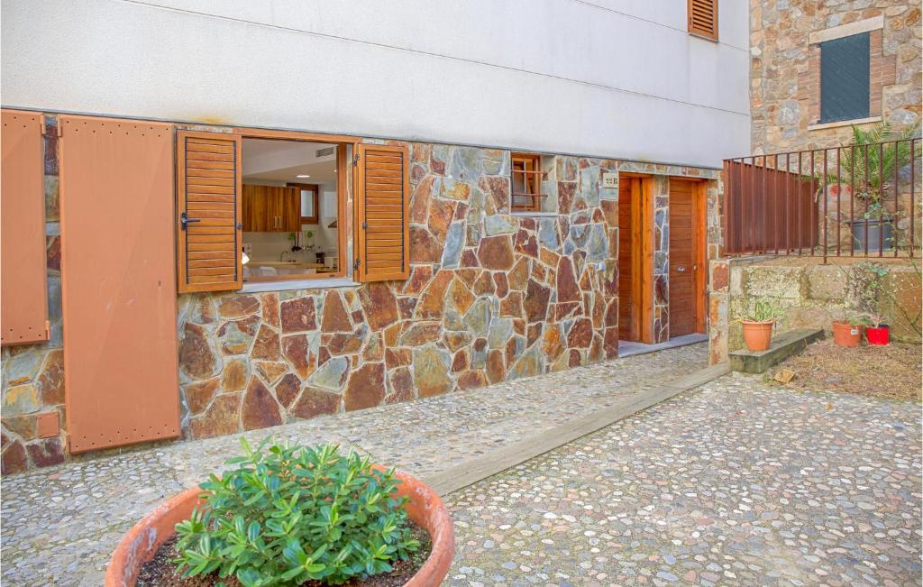a stone building with a plant in front of it at Cozy Apartment In Tossa De Mar, Girona in Tossa de Mar