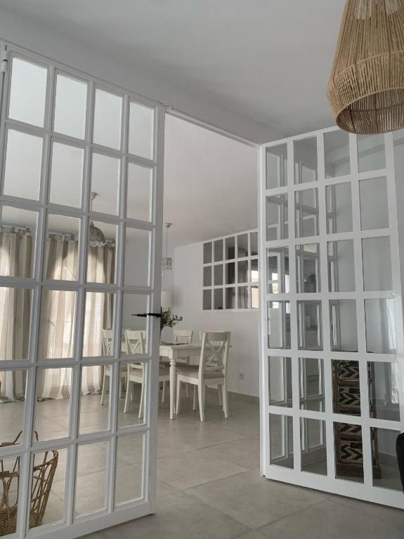 a white room with a table and a glass door at Altea Lighthouse in Altea