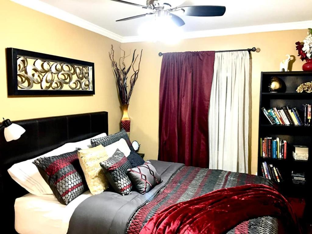 a bedroom with a bed with pillows on it at Charity's Haven II in Waldorf