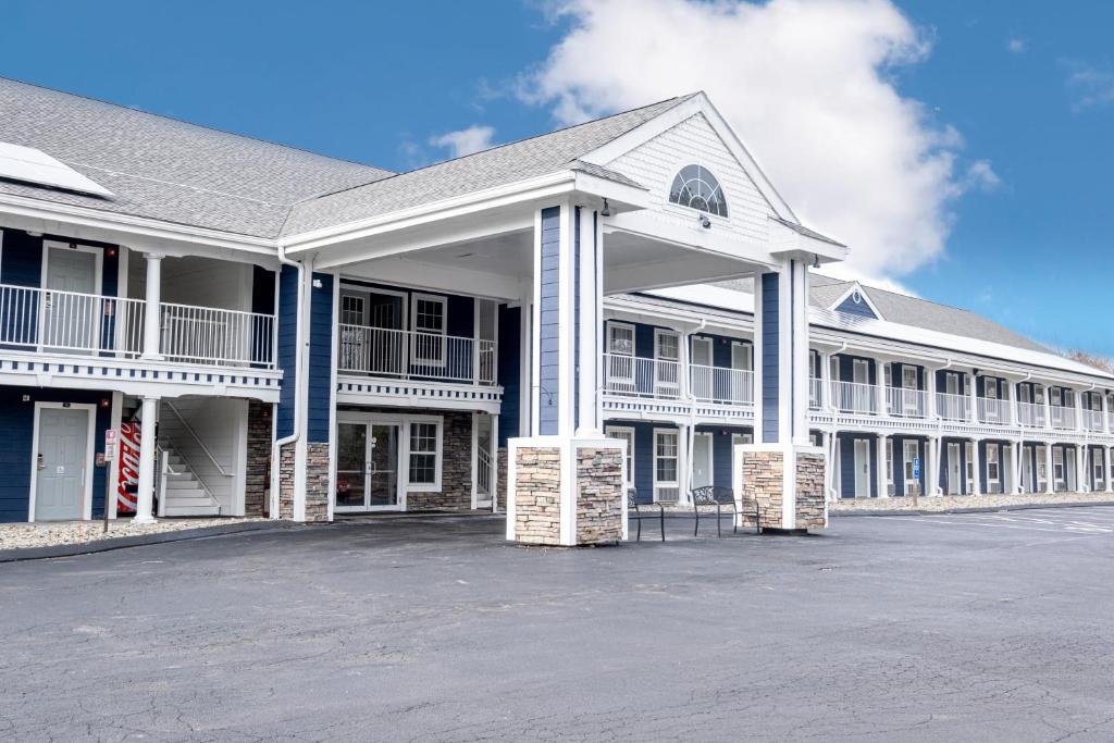 a large white building with a lot of windows at Hilltop Inn & Suites - North Stonington in North Stonington