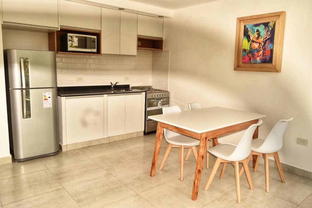 a kitchen with a table and chairs and a refrigerator at Ayres de Nieva 2 in San Salvador de Jujuy
