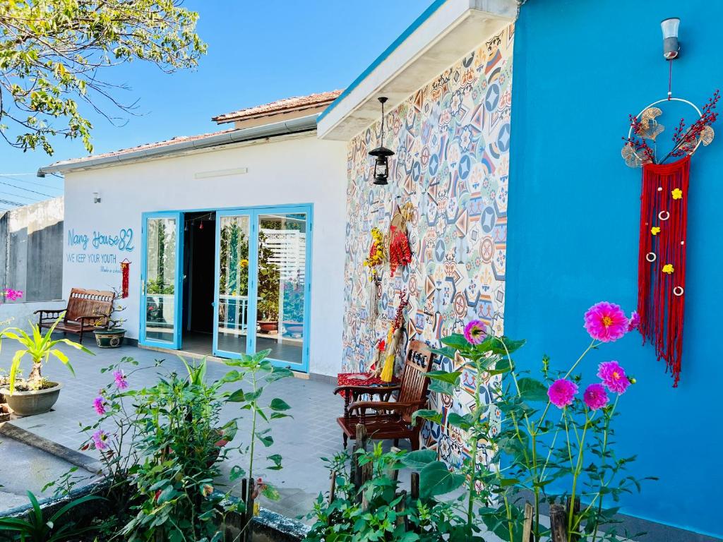 a mural on the side of a house with flowers at Nắng Real Home 82 in Kon Tum