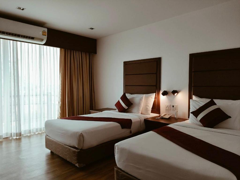 Postel nebo postele na pokoji v ubytování Teak Garden Resort, Chiang Rai