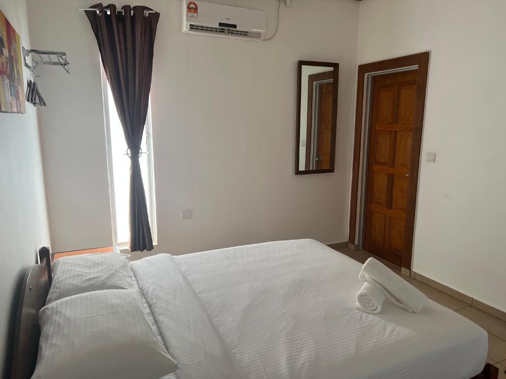 Postel nebo postele na pokoji v ubytování Hujung Kampung Resort
