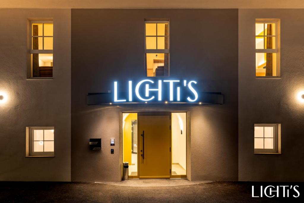 a lit up sign on the side of a building at Lichti´s Rooms & Appartements in Aspang Markt